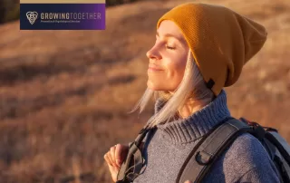 woman taking a deep, calm breath while enjoying hiking in fall weather