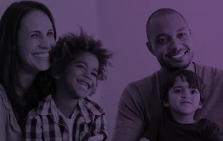 A family sits in an office building and talks to a family therapist.