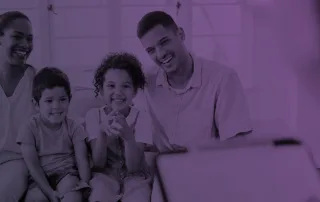 A family sits in an office building and talks to a therapist.