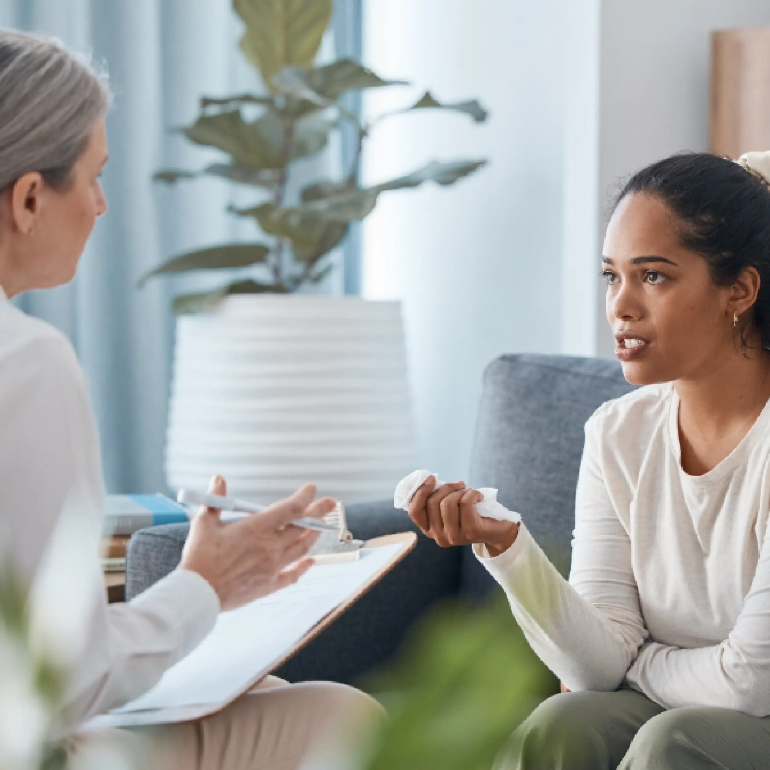 A person sits in a room and talks to their therapist.