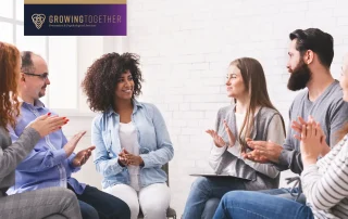 People encouraging each other in a group therapy session.