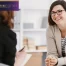 Happy woman during successful psychotherapy with counselor at clinic.