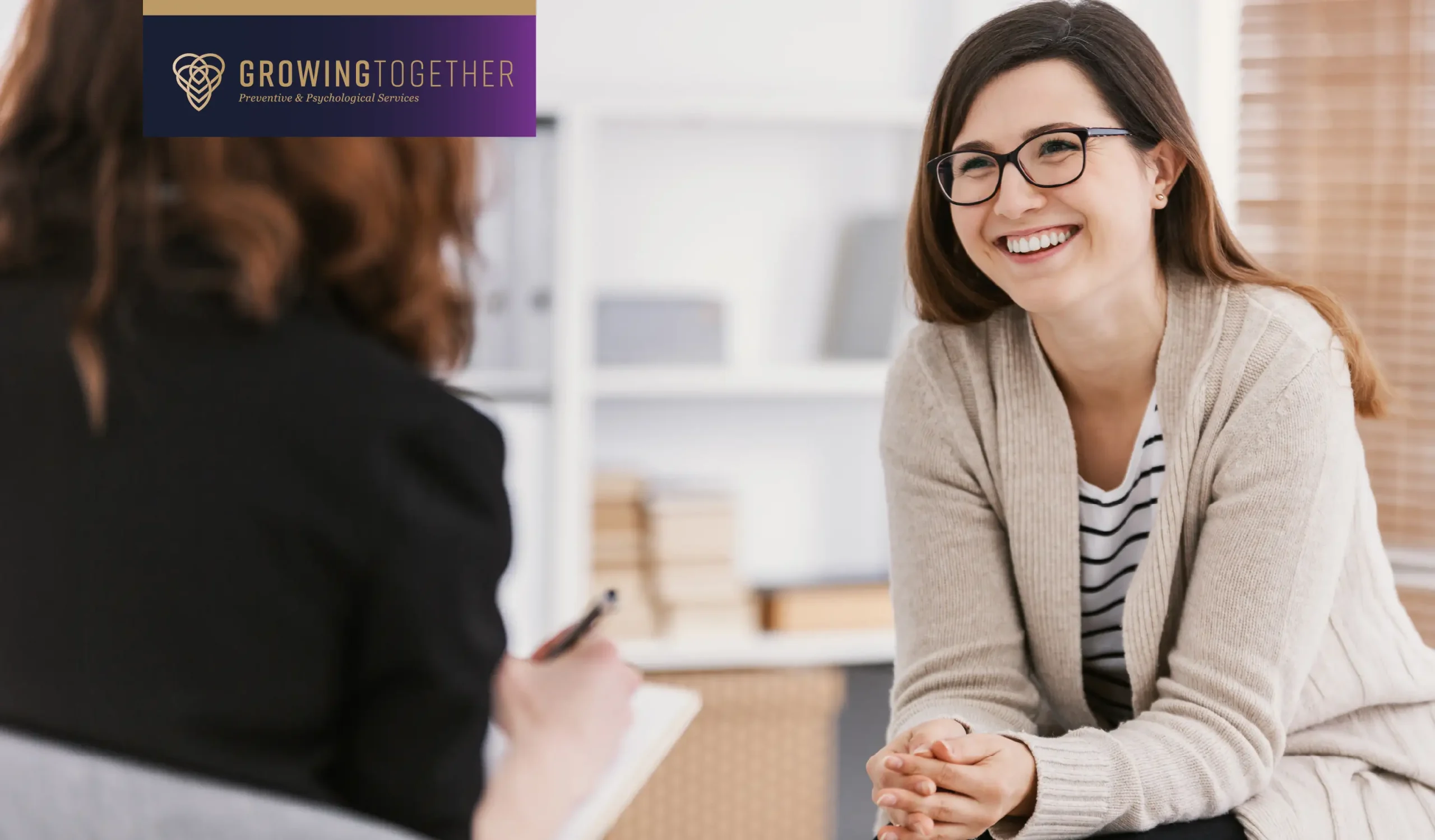 Happy woman during successful psychotherapy with counselor at clinic.